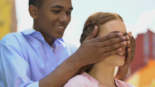 Playful Male Teen Walking to Girlfriend, Closing Eyes With Palms, Romantic Date