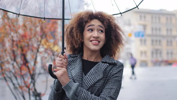 African American Girl Happy Woman Female Tourist Lady Stands in Strong Wind Rain Storm Cold Windy