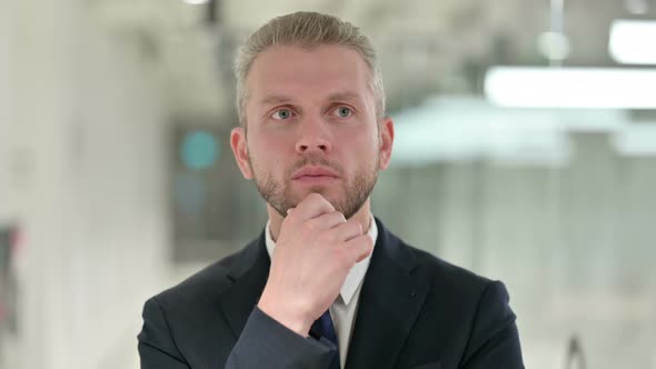 Portrait of Pensive Businessman Thinking About Something