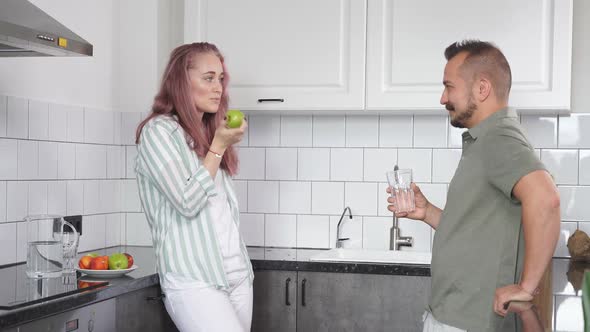 Caucasian Married Couple Have Talk in the Kitchen Beautiful Woman and Man Have Breakfast