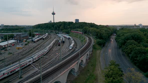 Train depot and railway yard aerial view of Cologne in Germany on a sunny evening with the tv tower