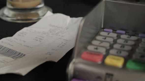 Hand checking receipt before paying for goods with cash close up shot