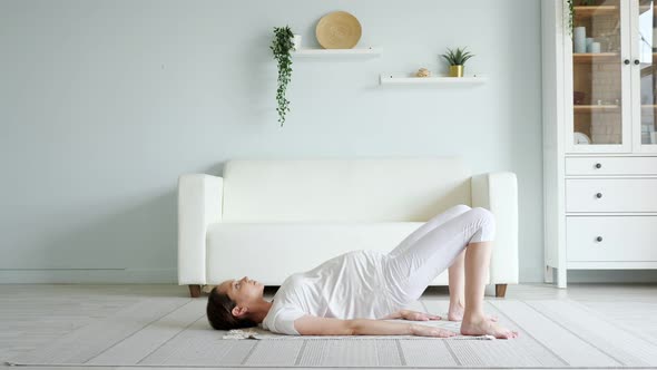 Pretty Pregnant Lady Does Exercises Practicing Yoga at Home