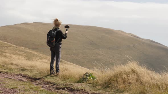 Female hiker  on Midzor peak close-up 4K 2160p 30fps UltraHD footage - Woman films nature and hikes 