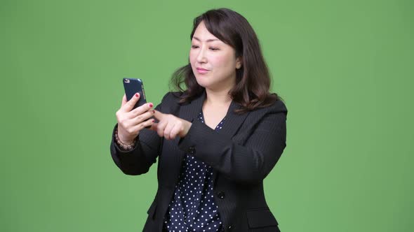 Mature Beautiful Asian Businesswoman Using Phone
