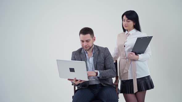 Business couple in studio. Portrait of caucasian business couple cooperating