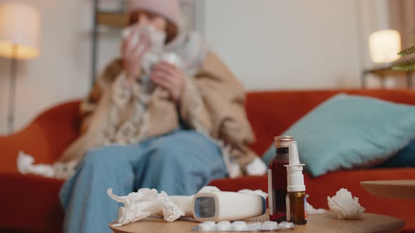 Sick Cold Woman Suffering From Cold or Allergy at Home in Living Room Blows Nose Snot Into Napkin