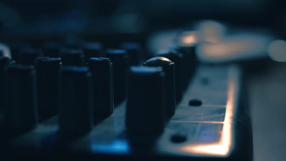 Macro of Sound Mixing Console. Mixer Console for Sound Production in Recording Studio. Poor Light