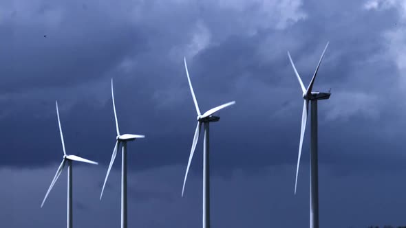 700590 Wind Turbines with Cloudy Sky, near Caen in Normandy, Slow Motion