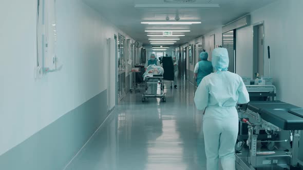 Hospital Hallway with Medical Staff Walking Through It