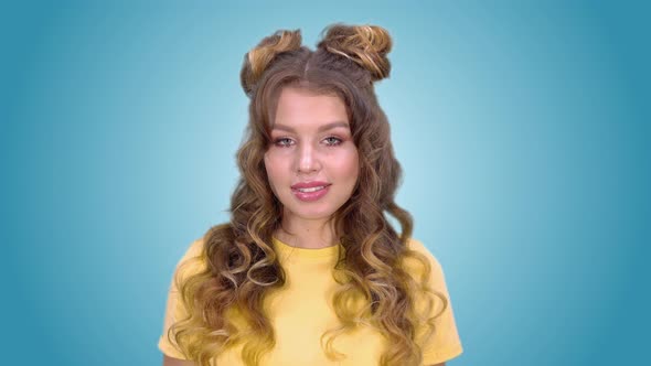 Beautiful Young Girl with Long Hair Puts a Finger to His Lips and Shows a Gesture of Silence