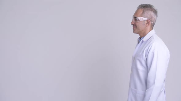 Profile View of Happy Persian Man Doctor Wearing Protective Glasses