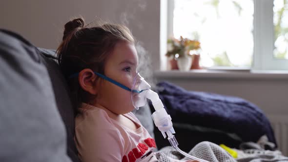 Sick Adorable Preschool Girl with Nebuliser Mask at Home