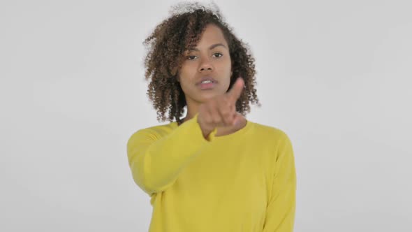 Young African Woman Pointing at Camera Inviting on White Background