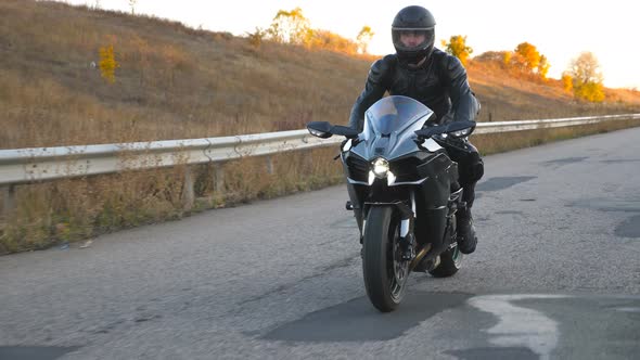 Man in Helmet Riding on Modern Sport Motorbike at Highway. Motorcyclist Racing His Motorcycle on