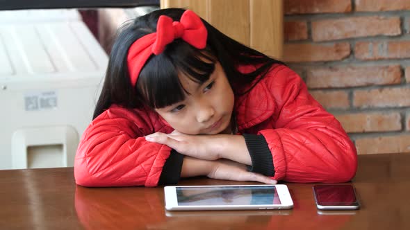 Little Girl Waiting Some One With Tablet And Phone