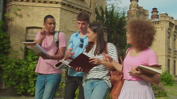 Mixed Race Students Preparing for Lecture Discussing Homework Outdoors