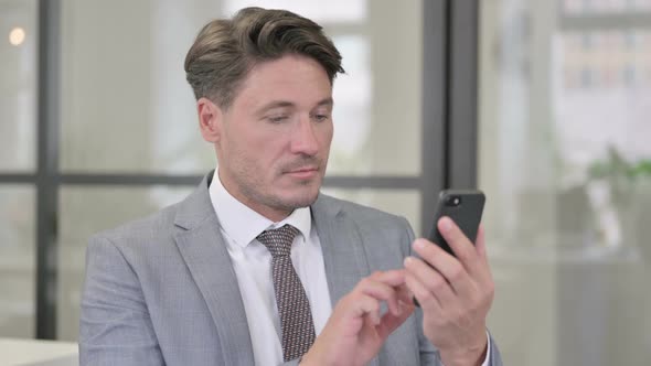 Middle Aged Man using Smartphone