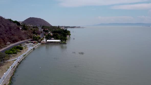 Rising aerial drone footage above Lake Chapala and Chapala town in Jalisco, Mexico