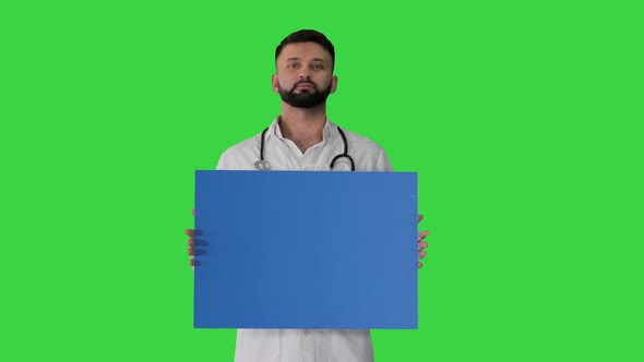 Doctor Holding a Blank Panel on a Green Screen, Chroma Key