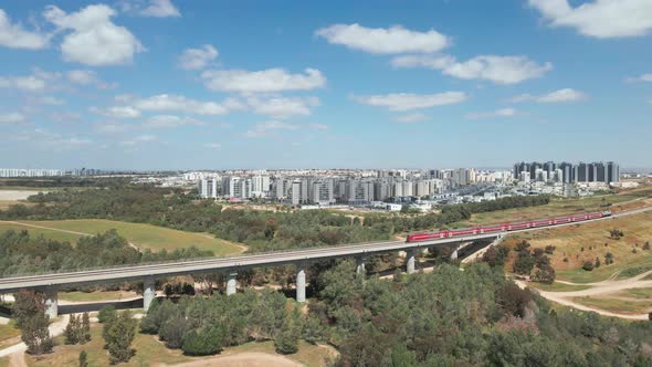 train on a bridge leaving southern district city at israel named by netivot