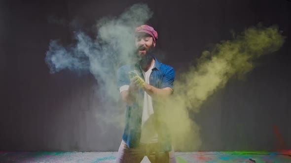 Man Dancer Showing Break-dancing Moves Against Colourful Powder Explosion