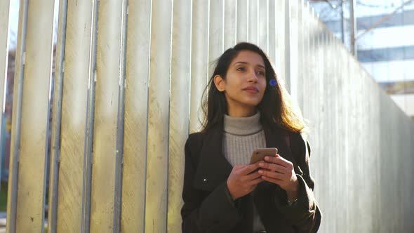 Slow motion shot of woman having a phone call in the city