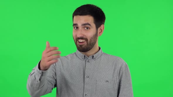 Portrait of Brunette Guy Is Showing Thumbs Up, Gesture Like. Green Screen