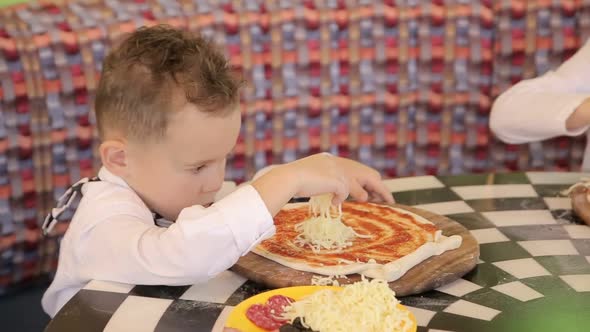 Children make pizza. Master class for children on cooking Italian pizza.