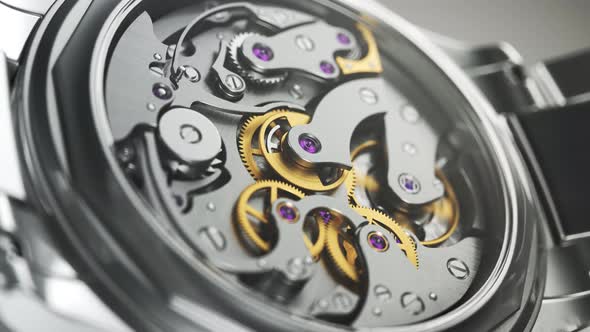 Closeup on the luxury watch with gears and mechanism visible through the glass.