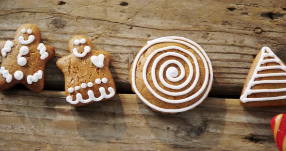 Various cookies and candy cane arranged on wooden table 4k