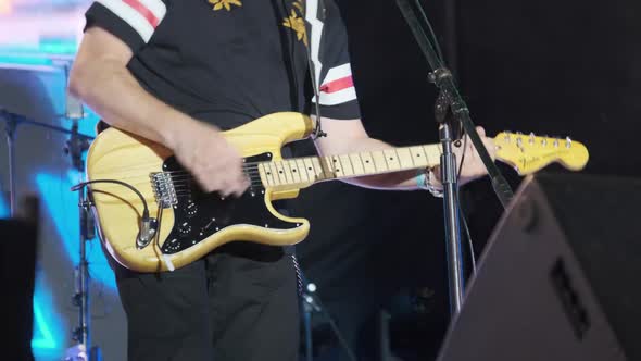 Guitarist at a Rock Concert Plays Electric Guitar on the Open Stage. Slow Motion