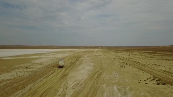 Road in the Steppes of Kazakhstan Muddy River. View on Very Long Road Till Horizon. 