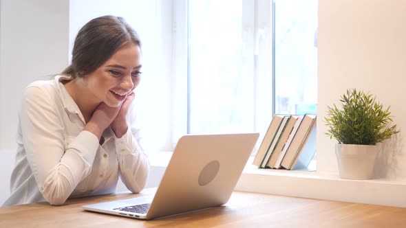 Working Girl Celebrating Success while Working on Laptop