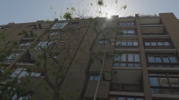 Madrid living apartment building with sun shining behind, motion view