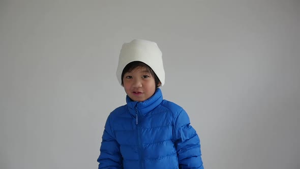Cute Asian Child In Blue Winter Clothes Open Palm Hands Slow Motion