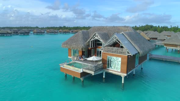 Aerial drone view of a luxury resort and overwater bungalows in Bora Bora tropical island