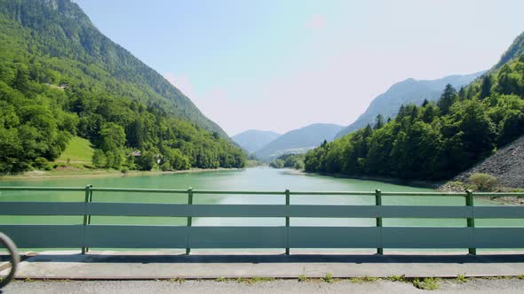 Mountain biker rides across an alpine dam