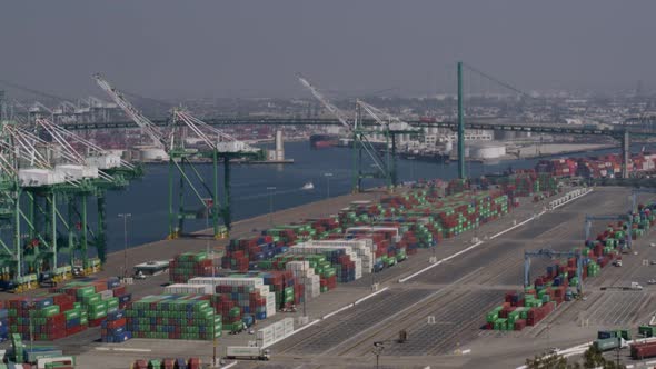 Aerial of cargo containers and cranes at shipping yard