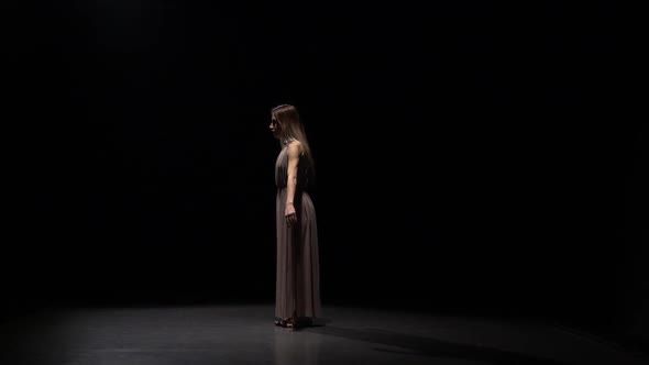 Slow Motion of Gorgeous Female Practicing Contemp in Dark Studio.