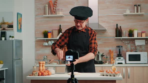 Elderly Man Filming Cooking Vlog