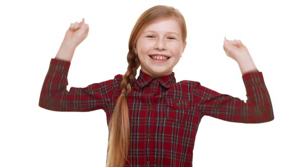 Young Funny Caucasian Girl with Plait of Hair Smiling and Jupming with Wide Arms Spread Open