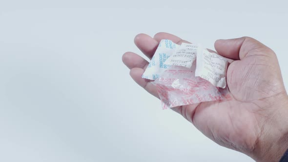 Hand Holds Silica Gel Packets
