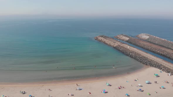 Drone flies forward into an aerial view of the beach of  São Torpes