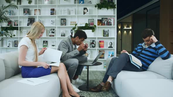 Black Man Sharing Good News with Coworkers. African-American Man Surfing Laptop and Sharing Great