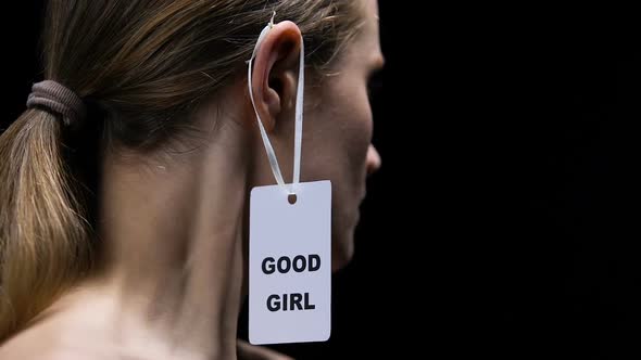 Strong Female Tearing Good Girl Label From Ear, Protesting Against Prejudice