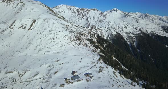 Aerial drone view of snow covered mountains in the winter.