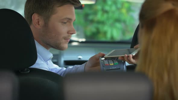 Taxi Client Paying for Trip by Smartphone Application, Contactless Transaction