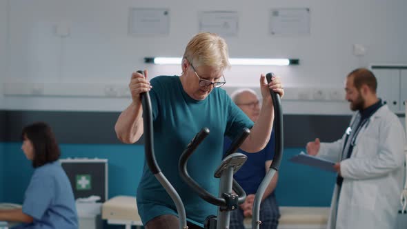 Portrait of Senior Patient with Mechanical Disorders Using Stationary Bicycle