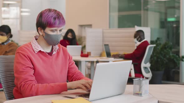 Hipster Woman in Face Mask Working in Office